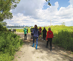 Group of people walking towards a lake