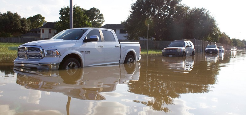 parked vehicles sit in flood waters following extreme rainfall event