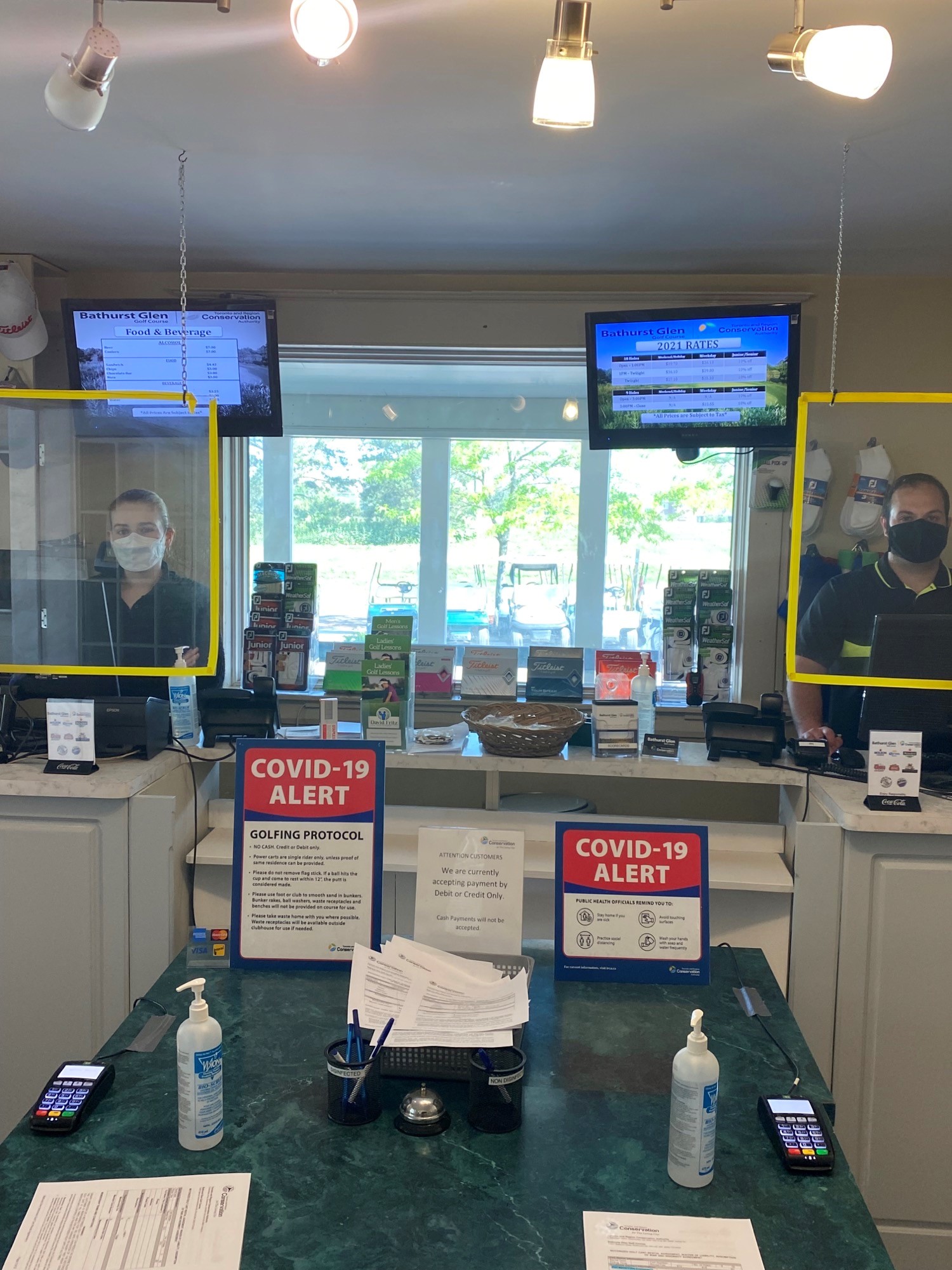 COVID-19 protective equipment is installed at the check-in desk at Bathurst Glen Golf Course and Driving Range