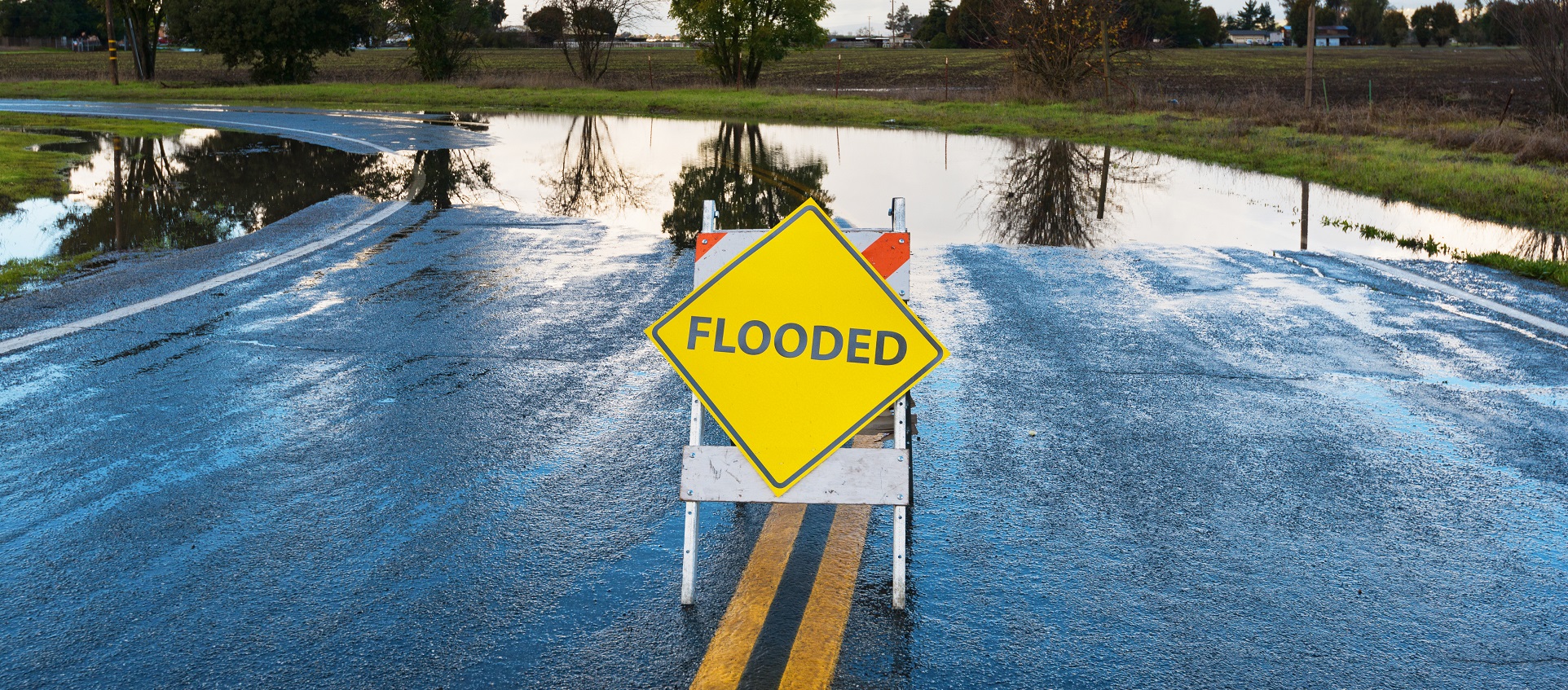 warning sign on flooded street