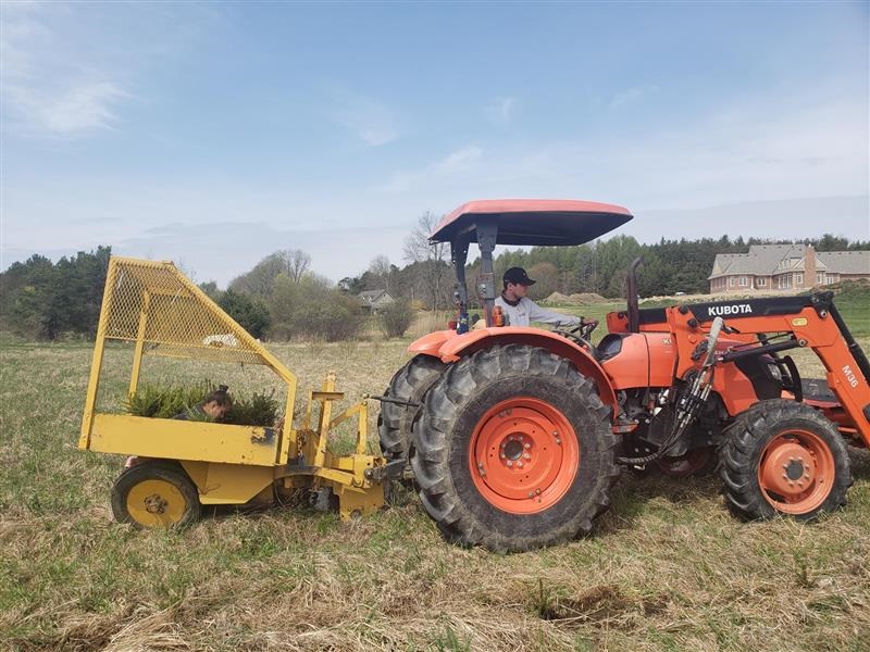 TRCA field staff use heavy equipment to plant seedlings