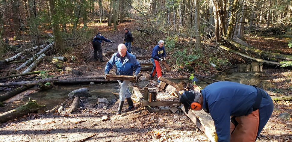 Green Durham Association volunteers remove an old boardwalk in TRCA’s East Duffins Headwaters Properties in Uxbridge