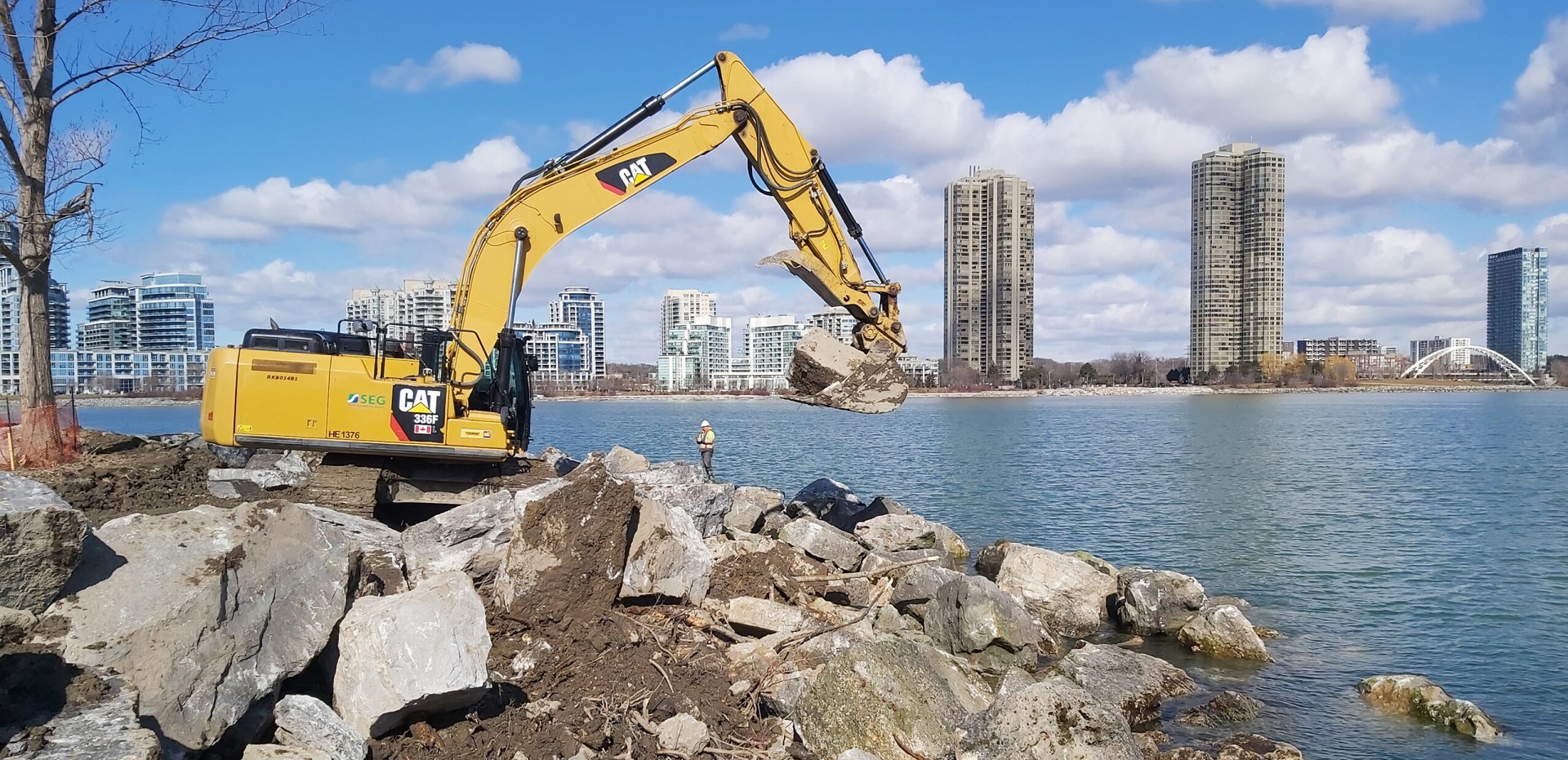 TRCA construction team works with heavy equipment on the Lake Ontario shoreline