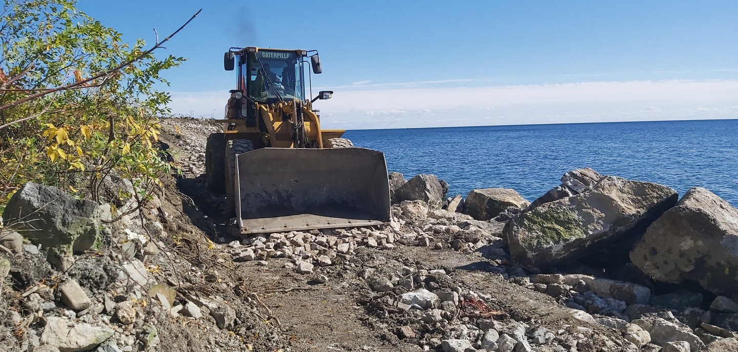 TRCA construction staff use front end loader to move materials at construction site on Lake Ontario waterfront