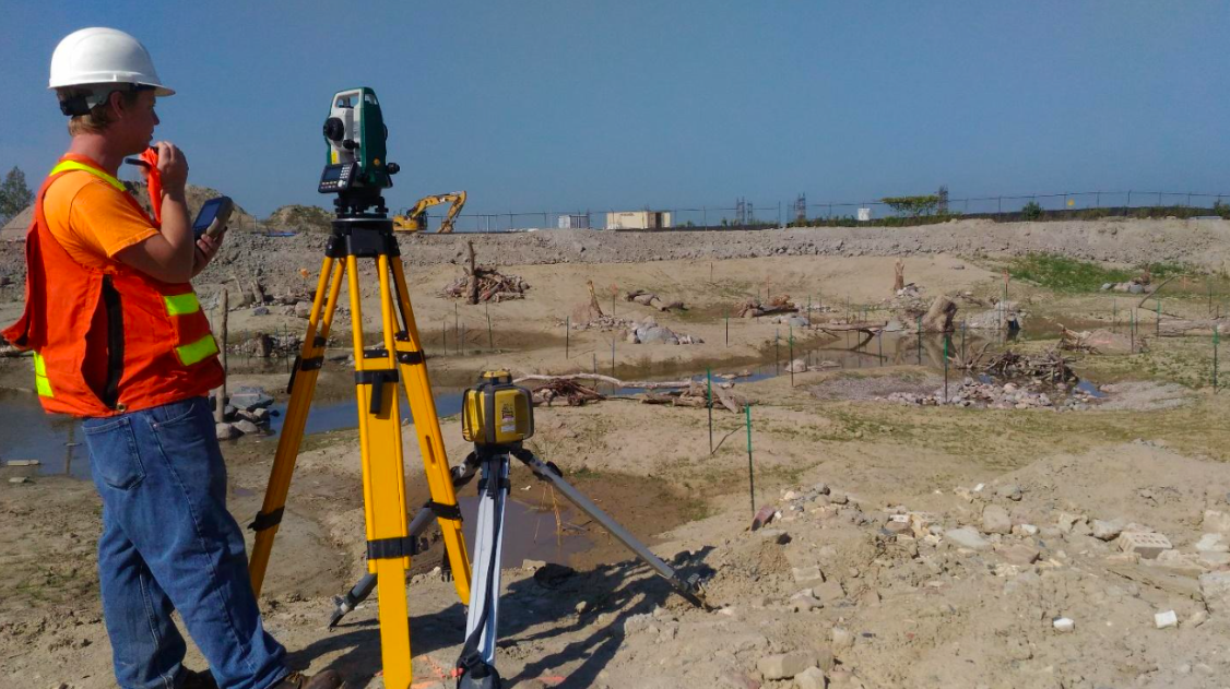 TRCA Survey Drafting and Design team member conducts survey at construction site